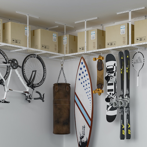 Fleximounts Overhead Garage Storage system on a white walled corner with boxes , bikes and sport equipment hanging from it as part of Home Network The Secret to Storing Holiday Decorations in Small Spaces