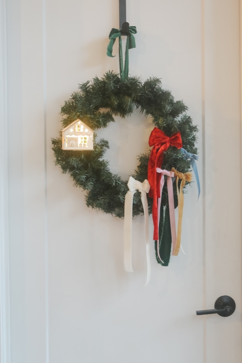 bow garland with gingerbread house on door