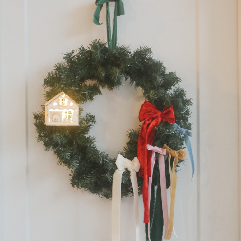 bow garland with gingerbread house on door