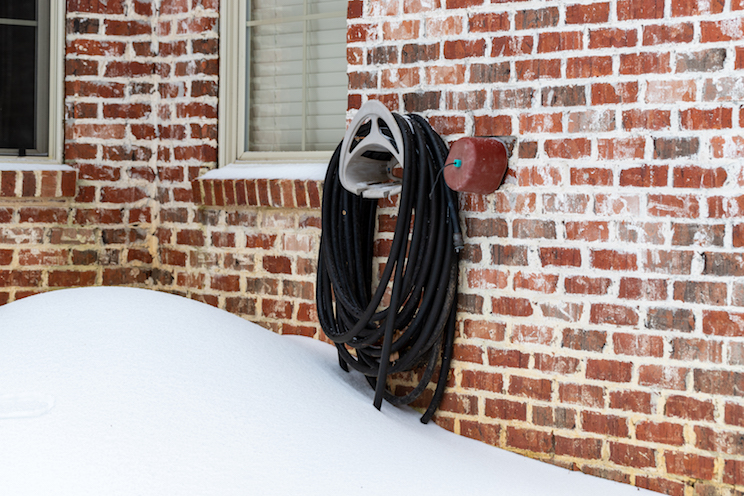 Faucet cover installed on water faucet to protect it from freezing temperatures