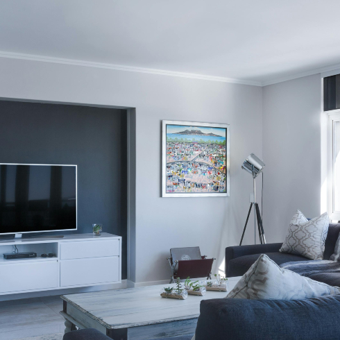 An image of a bright living room with an airy ceiling