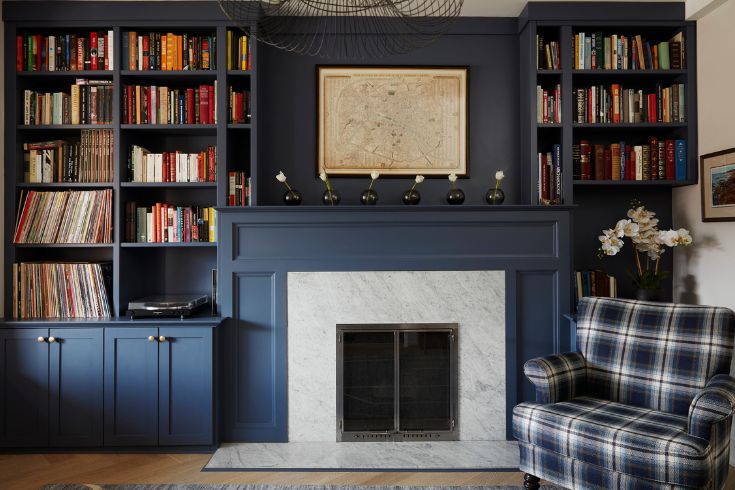 Colour-drenched living room with fireplace and plaid chair