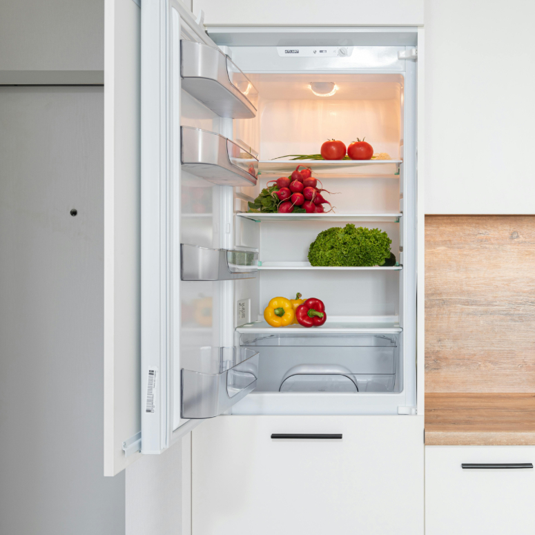 A tidy and minimally stocked fridge with fresh produce