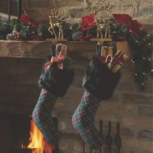 Plaid Christmas stockings hanging on a mantle