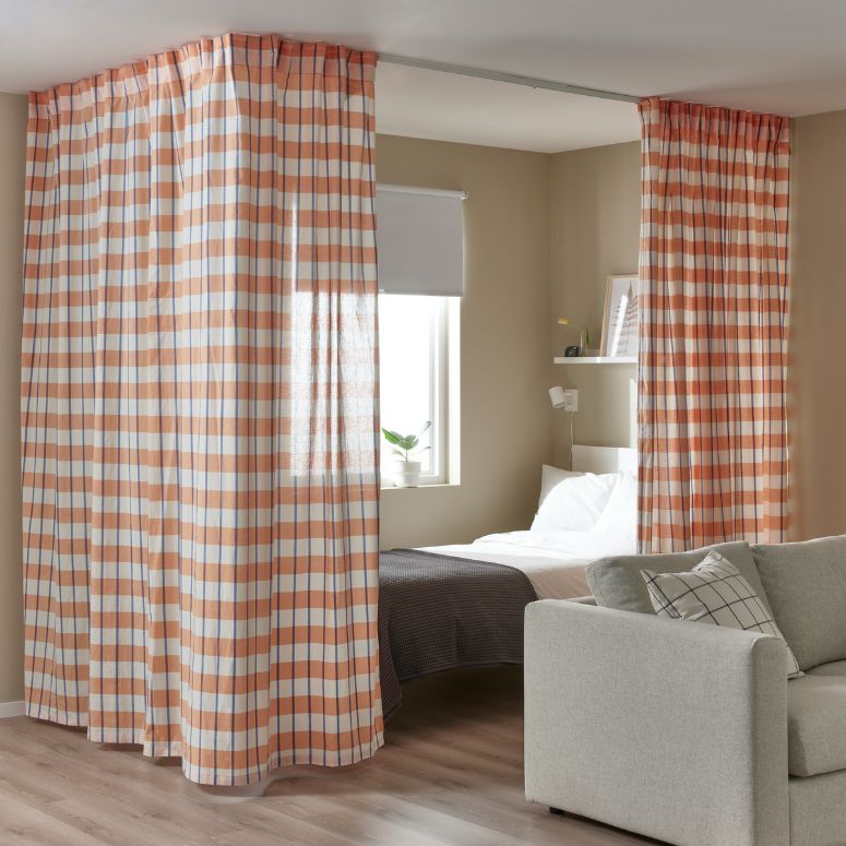 Plaid drapes surrounding bed