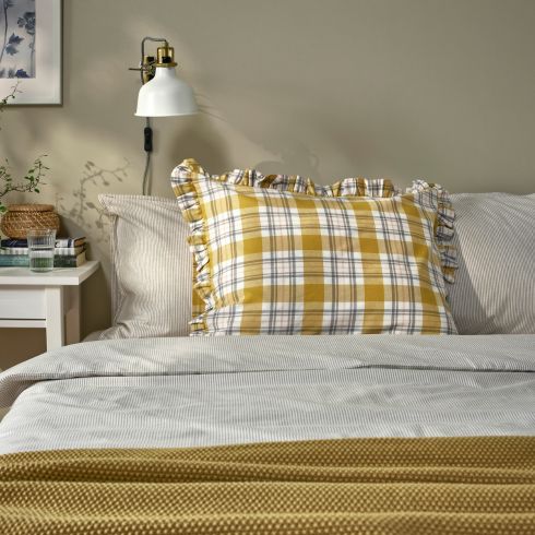 Yellow plaid pillow in bedroom