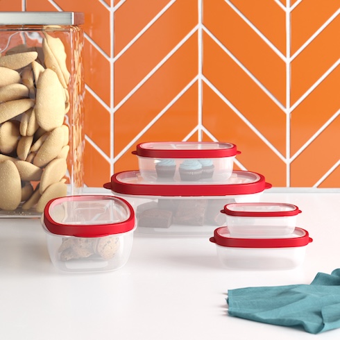 Five storage containers with red lids store leftover on a white counter.