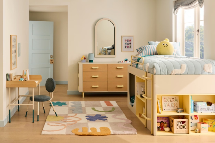 Mulitple pieces from Eva Chen's collaborative collection with West Elm Kids make up this lively kids bedroom design, including a raise bookshelf bed, a dresser, wall mirror, adjustable work desk and a colourful rug.
