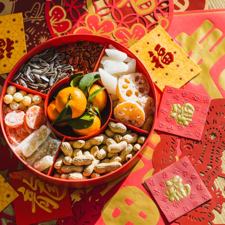 Candy box with variety of Chinese new year snacks and Chinese new year decorations