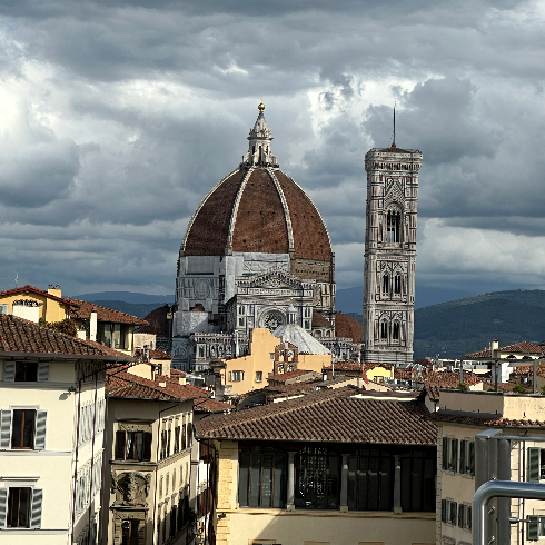 The Florence, Italy skyline with a view of the Duomo, bell tower and other historic buildings.