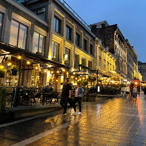 A man and a woman walk along a cobblestone street in Old Montréal, Québec.