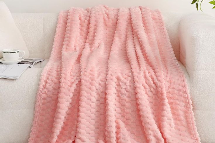Pink throw blanket on white sofa