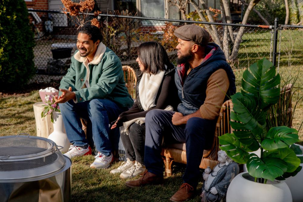 Sebastian Clovis seated outside with homeowners