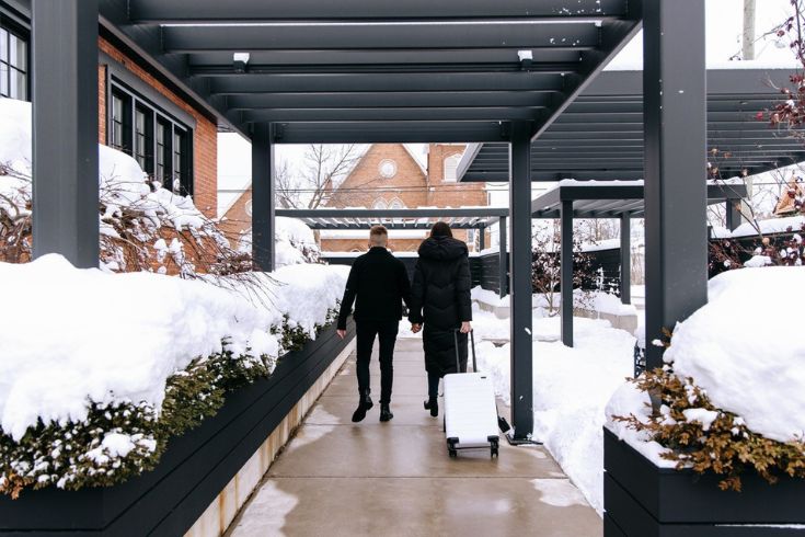 Two people walking through the VanderMarck hotel