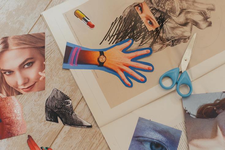 Picture Cutouts from a fashion magazine, a pair of blue handled scissors and an Open Book on a wood floor as part of a How to Start a Junk Journal post for Home Network
