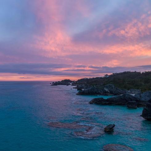 Green Trees Near Body of Water Under Blue and Orange Sky during Golden Hour in Bermuda