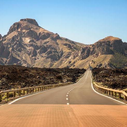 Gray Asphalt Road Towards Brown Mountain on Tenerife, Spain, as part of HOME Network's 10 Unexpected Sunny Destinations For Your Winter Escape