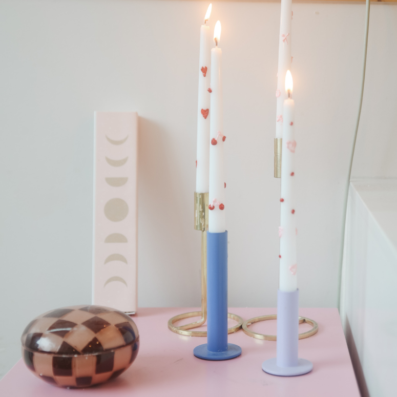 painted candles on colourful table