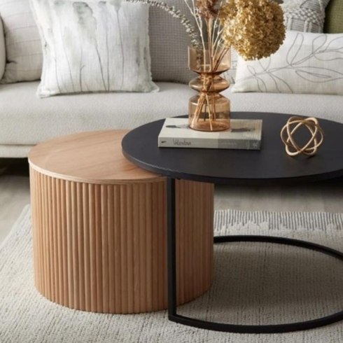 Nesting coffee table with black metal top and natural wood.