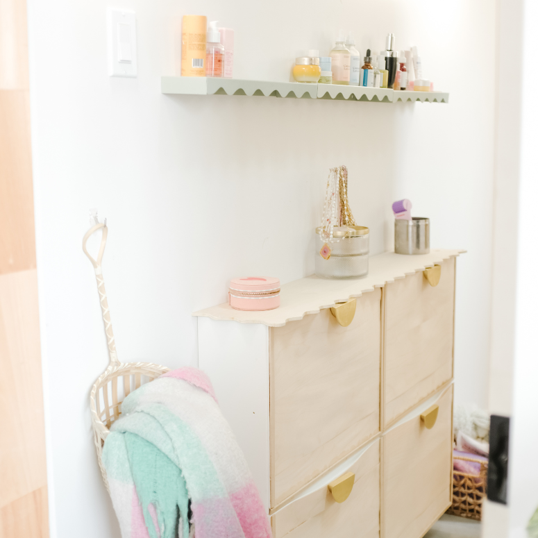 bathroom wit an ikea shoe storage and shelves on top
