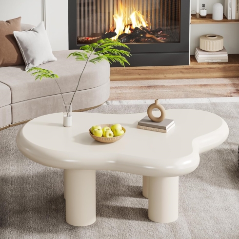 A cream-coloured, cloud shaped coffee table.