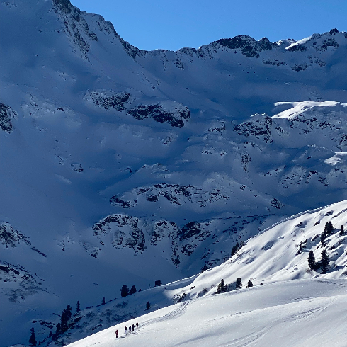 Skiiers on a mountain run at Arlberg Ski Resort in Austria.