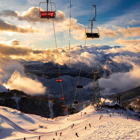 Skiiers on a snowy mountain at Catedral Alta Patagonia Ski Resort in Argentina.