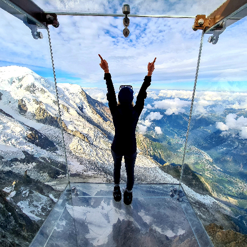 A woman standing on the Skywalk at the Chamonix-Mont-Blanc Ski Resort in France.