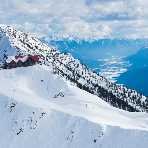 A red cabin on a mountain at Kicking Horse Ski Resort in Golden, British Columbia.