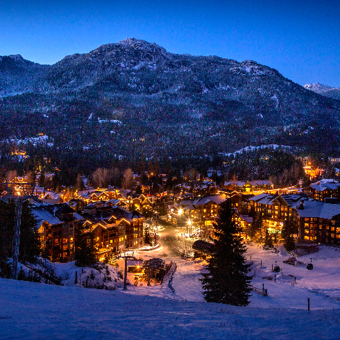 The Whistler Blackcomb Ski Resort in British Colubmia at night with the town all lit up.