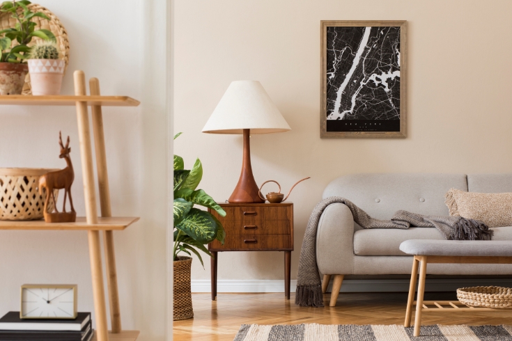 Cozy living room with couch, coffee table and lamp on a wooden side drawer.