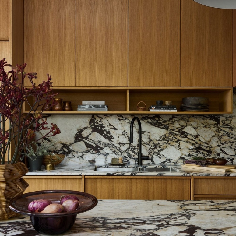 Kitchen featuring marble countertop and wood cabinets