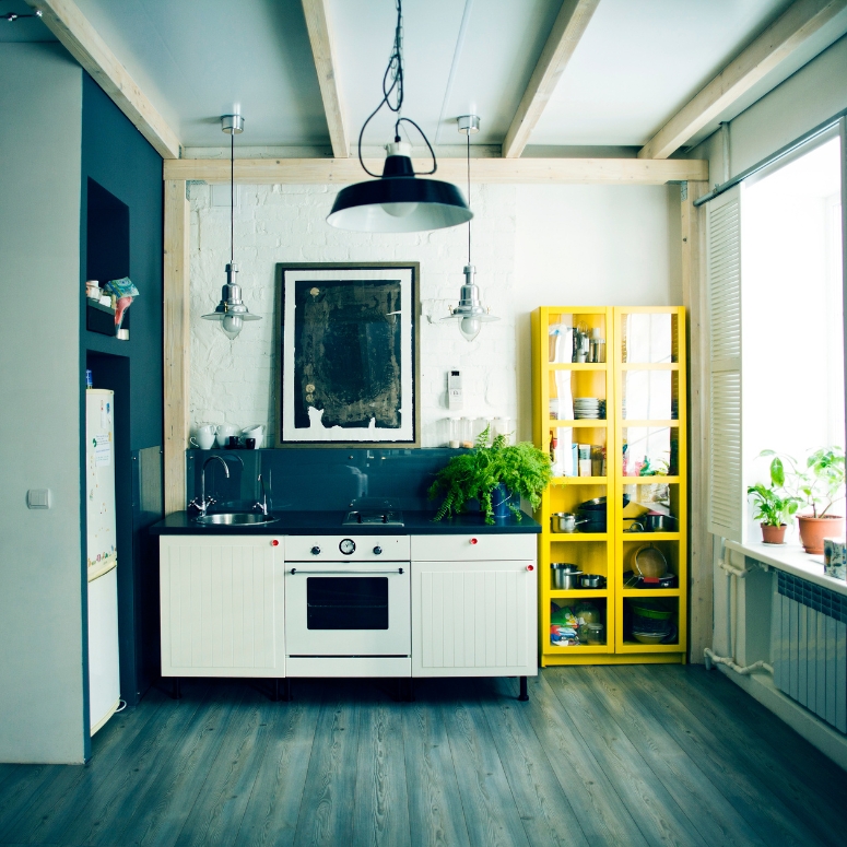 Small apartment kitchen featuring sink, oven and shelves.