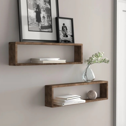 Two pieces of rectangular wood floating shelves on the wall.