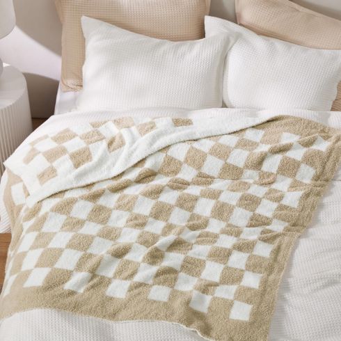 Checkered throw blanket on bed