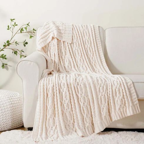 White knitted throw blanket on white sofa