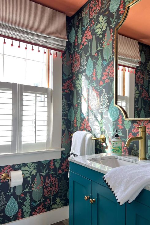 Powder room with wallpaper, teal vanity and striped roman blind