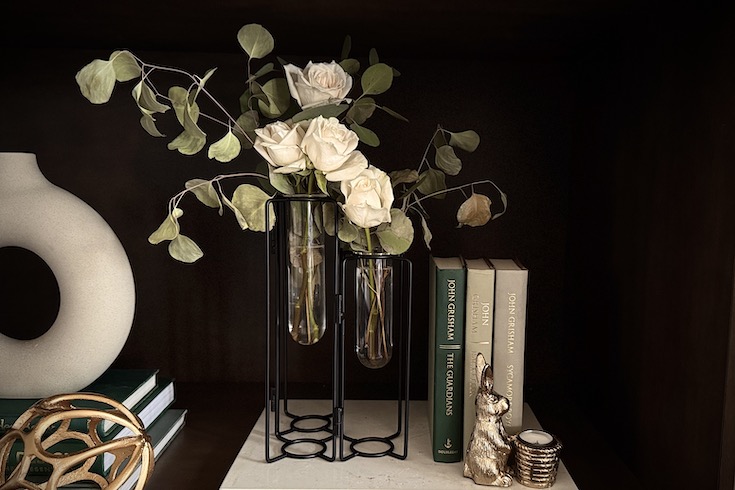 White roses in geometrical vase.