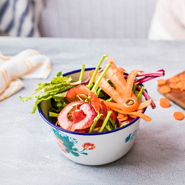 Fresh vegetable scraps in a bowl for compost.