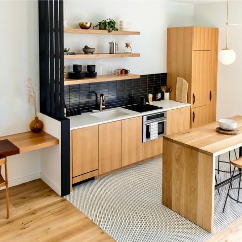 An open kitchen concept with wood furniture and a clear pathway.