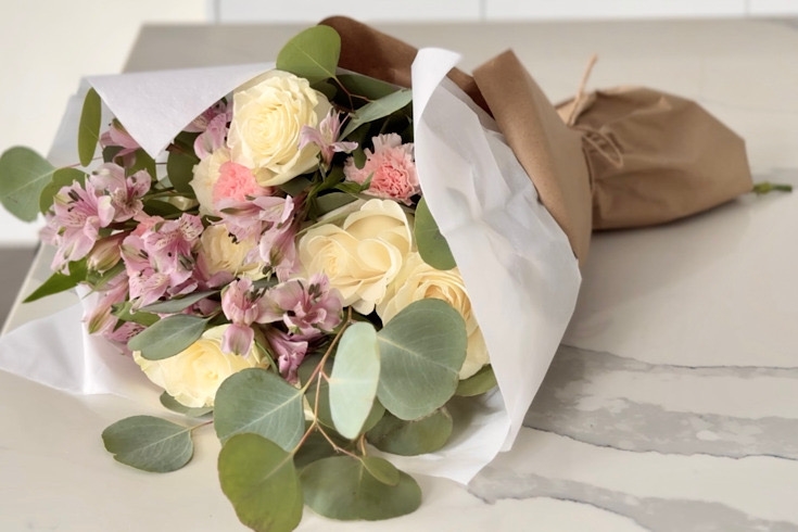Final flower bouquet wrapped nicely on the table.