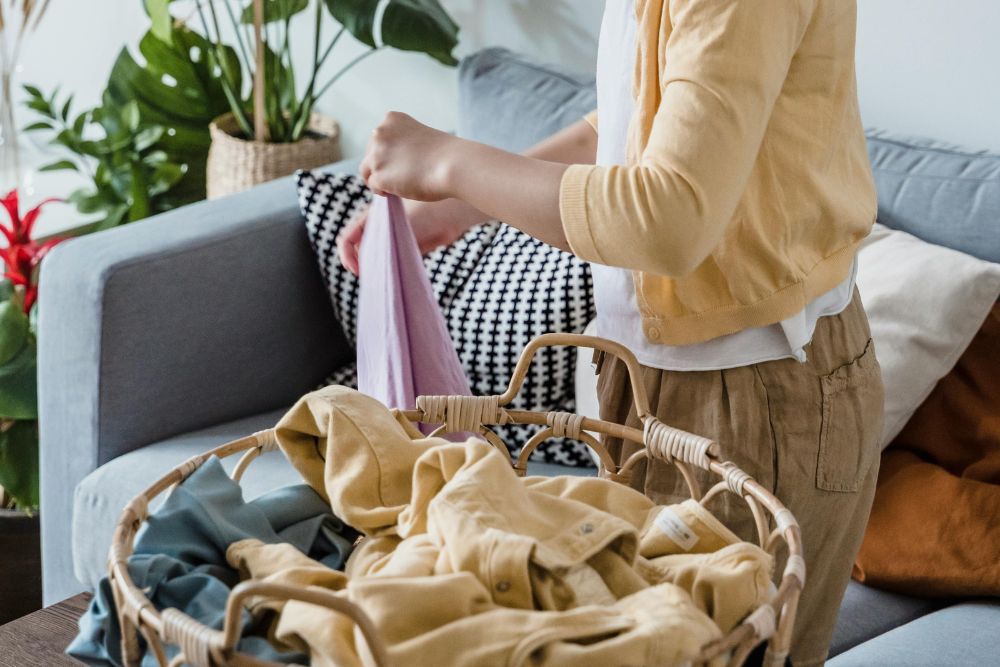 Girl sorting through clothes in a basket
