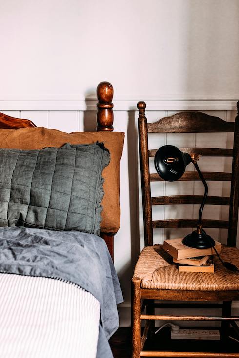 Black Desk Lamp on Top of the Chair Near Bed