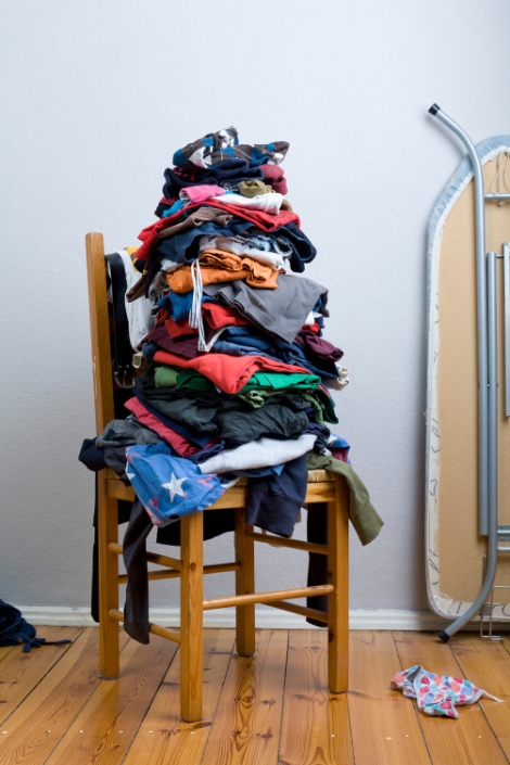 A big untidy stack of clean clothes waiting to be ironed.