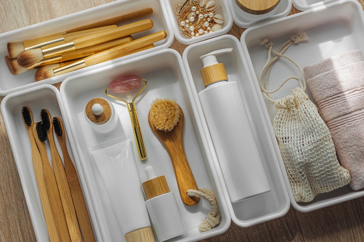 Cosmetics products arranged in white organizers. 