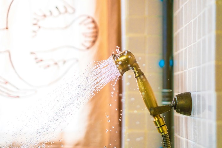 Gold shower head with water coming out