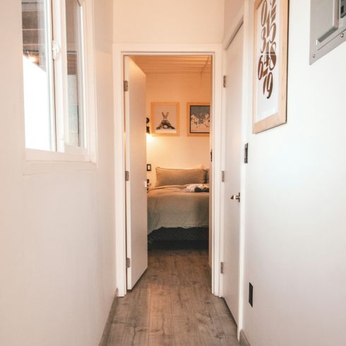 A long white hallway in a small apartment.