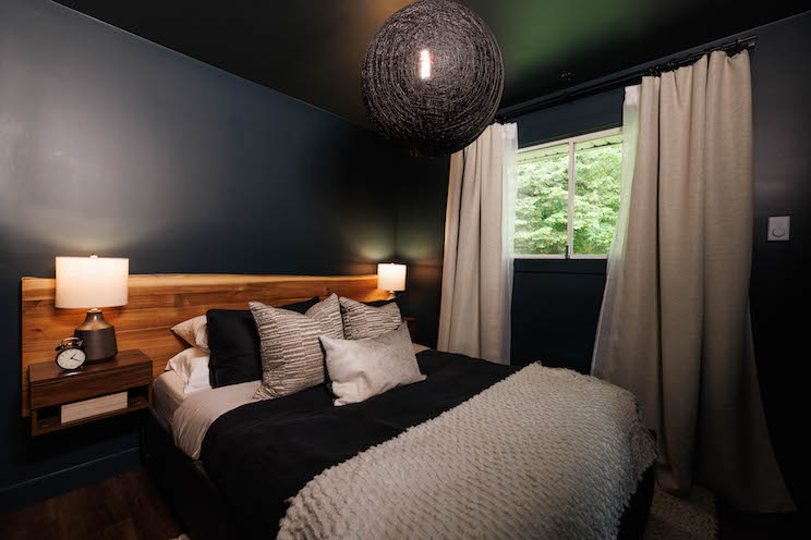 Dark bedroom with black paint and wood finishes