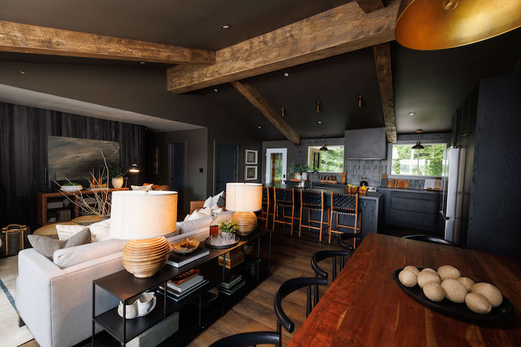 Moody dining room with black paint and exposed wood beams