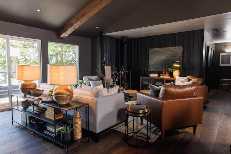 An open-concept living room with views of the lake and a fireplace